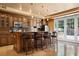 Entertainer's bar area featuring granite countertops, custom cabinetry, and stainless steel appliances at 1016 Sable Mist Ct, Las Vegas, NV 89144