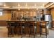 Stylish bar area with wood cabinetry, granite countertops, and seating for four at 1016 Sable Mist Ct, Las Vegas, NV 89144