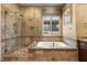 Luxurious bathroom with separate glass shower and a soaking tub at 1016 Sable Mist Ct, Las Vegas, NV 89144