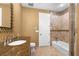 A bathroom featuring a single sink with decorative mirror and a shower-tub combination with decorative tile accents at 1016 Sable Mist Ct, Las Vegas, NV 89144