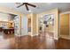 Open concept bedroom featuring wood floors, a ceiling fan, and ensuite bathroom at 1016 Sable Mist Ct, Las Vegas, NV 89144