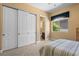 Bedroom features a striped bedspread, window with blind and large white double door closet with black hardware at 1016 Sable Mist Ct, Las Vegas, NV 89144
