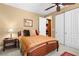 A comfortable bedroom featuring carpet flooring, ceiling fan, side table with lamp, and closet at 1016 Sable Mist Ct, Las Vegas, NV 89144