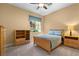 Bedroom features a ceiling fan, large window with blind and wood furniture at 1016 Sable Mist Ct, Las Vegas, NV 89144