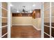 Spacious bedroom with built-in cabinetry and wood floors viewed through french doors at 1016 Sable Mist Ct, Las Vegas, NV 89144