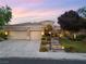Attractive home featuring a three-car garage, desert landscaping, and a stone walkway leading to the front entrance at 1016 Sable Mist Ct, Las Vegas, NV 89144