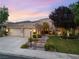 Charming single-story home boasting mature landscaping, a three-car garage, and a welcoming stone walkway at 1016 Sable Mist Ct, Las Vegas, NV 89144