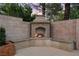 Outdoor fireplace with stone surround and built-in seating area, perfect for entertaining at 1016 Sable Mist Ct, Las Vegas, NV 89144