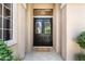 Elegant double front doors with decorative glass accents and stone pathway at 1016 Sable Mist Ct, Las Vegas, NV 89144