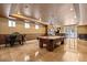Open-concept game room featuring a pool table, adjacent dining area, and exterior patio access at 1016 Sable Mist Ct, Las Vegas, NV 89144