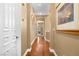 Hallway features art, hardwood floors and white doors at 1016 Sable Mist Ct, Las Vegas, NV 89144