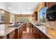 Open concept kitchen with granite countertops, stainless steel appliances, and island cooktop at 1016 Sable Mist Ct, Las Vegas, NV 89144