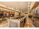 This is a chef's kitchen with an oversized island, custom cabinetry, and stainless steel appliances at 1016 Sable Mist Ct, Las Vegas, NV 89144