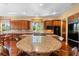 Gourmet kitchen featuring a center island, granite countertops, and wooden cabinetry at 1016 Sable Mist Ct, Las Vegas, NV 89144