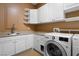 Laundry room with sink, cabinets, shelving and front loading washer and dryer at 1016 Sable Mist Ct, Las Vegas, NV 89144