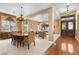 Open-concept living and dining area with hardwood and carpet flooring and chandeliers at 1016 Sable Mist Ct, Las Vegas, NV 89144
