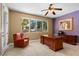 A bright office space with large windows offering backyard views and a substantial desk and chair at 1016 Sable Mist Ct, Las Vegas, NV 89144