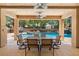 Covered patio shows a dining area overlooking the pool with waterfall and hot tub at 1016 Sable Mist Ct, Las Vegas, NV 89144