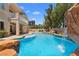 A captivating backyard paradise with rock waterfall feature and lush greenery at 1016 Sable Mist Ct, Las Vegas, NV 89144