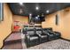 Home theater with tiered seating, popcorn machine, and black ceiling for an immersive viewing experience at 1016 Sable Mist Ct, Las Vegas, NV 89144