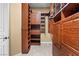 Walk-in closet with wooden organizers and built-in shelving at 1016 Sable Mist Ct, Las Vegas, NV 89144