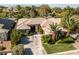 An elevated front view of a single story home with desert landscaping, and a tile roof at 10320 Luxembourg Ave, Las Vegas, NV 89145