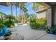Lush backyard showcases a sparkling pool, spa, mature palms, and comfortable patio furniture at 10320 Luxembourg Ave, Las Vegas, NV 89145