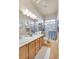 Bright bathroom with double sinks, tile flooring, a glass enclosed shower and plenty of counter space at 10320 Luxembourg Ave, Las Vegas, NV 89145
