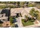 Stunning single-story home with a tile roof, circular driveway, and lush landscaping at 10320 Luxembourg Ave, Las Vegas, NV 89145