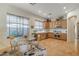 Bright kitchen featuring wooden cabinetry, stainless steel appliances, tile flooring, and breakfast nook at 10320 Luxembourg Ave, Las Vegas, NV 89145