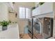 Laundry room features a washer, dryer, sink and plenty of storage at 10320 Luxembourg Ave, Las Vegas, NV 89145