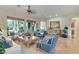 Cozy living room featuring stylish furniture, tile flooring, and large windows offering natural light at 10320 Luxembourg Ave, Las Vegas, NV 89145