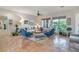 Spacious living room with comfortable seating, neutral paint, tiled floors, and bright natural light at 10320 Luxembourg Ave, Las Vegas, NV 89145