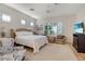 Serene main bedroom with neutral tones, plantation shutters, and a cozy seating area at 10320 Luxembourg Ave, Las Vegas, NV 89145