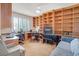 Well-lit office space with custom built-in shelving, a sofa, and plenty of room for work at 10320 Luxembourg Ave, Las Vegas, NV 89145
