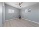A bedroom features two windows, light wood floors, and a modern ceiling fan at 104 Stanford St, Las Vegas, NV 89107