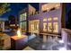 Inviting backyard pool with a fire pit, water feature, and modern home exterior at twilight at 10752 Patina Hills Ct, Las Vegas, NV 89135