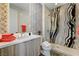 Bathroom featuring a glass enclosed shower, modern vanity, and accent wall at 10752 Patina Hills Ct, Las Vegas, NV 89135