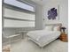 Bright bedroom with a sleek modern design, a large window, and stylish minimalist decor at 10752 Patina Hills Ct, Las Vegas, NV 89135