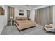 Stylish bedroom with neutral bedding, accent tables, and plush carpet at 10752 Patina Hills Ct, Las Vegas, NV 89135