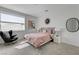 Well-lit bedroom featuring a large window, modern furnishings, and tasteful decor at 10752 Patina Hills Ct, Las Vegas, NV 89135