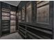 Walk-in closet with customized shelving and drawers and modern hardware at 10752 Patina Hills Ct, Las Vegas, NV 89135