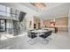 Bright dining area adjacent to kitchen with stainless steel appliances and modern staircase at 10752 Patina Hills Ct, Las Vegas, NV 89135