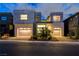 Striking modern home featuring a well-manicured front yard, two-car garage, and contemporary design at 10752 Patina Hills Ct, Las Vegas, NV 89135