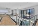 Modern entryway featuring a glass railing staircase, chandelier, and plenty of natural light at 10752 Patina Hills Ct, Las Vegas, NV 89135