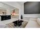 Open concept living space with a modern kitchen, fireplace, and comfortable seating area at 10752 Patina Hills Ct, Las Vegas, NV 89135