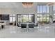 Bright and open living area with high ceilings, modern lighting, and expansive windows at 10752 Patina Hills Ct, Las Vegas, NV 89135