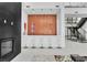 Bright, open living space with a bar area, fireplace and modern staircase at 10752 Patina Hills Ct, Las Vegas, NV 89135