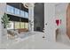 Bright, open living room with high ceilings, large windows, modern decor and backyard views at 10752 Patina Hills Ct, Las Vegas, NV 89135