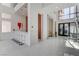 Spacious open-concept living area with modern decor, a wet bar, and staircase access at 10752 Patina Hills Ct, Las Vegas, NV 89135